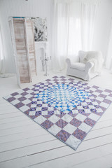 Patchwork quilt. Part of patchwork quilt in a white interior. Handmade. - obrazy, fototapety, plakaty