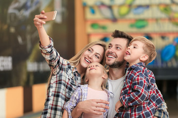 Fototapeta premium Family taking selfie at bowling club