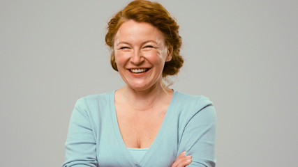 Mid aged actress showing emotions of joy. Actress in studio shows the emotion of joy. Close up...