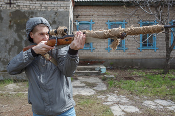 The man looks in a weapon sight