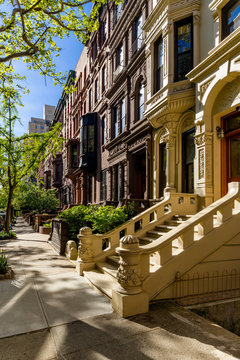 Row of brownstones with doorsteps and ornament in morning light. Upper West Side Street, Manhattan, New York City