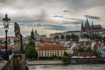 Fototapeta premium Colorful Prague gothic Castle above the River Vltava with Charles Bridge after Sunset, Czech Republic