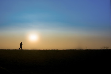 Obraz na płótnie Canvas Early morning lonely jogger