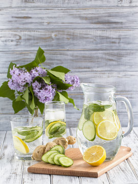 Dietary Detox Drink With Lemon Juice, Ginger, Cucumber And Mint Leaves In Clear Water With Ice.