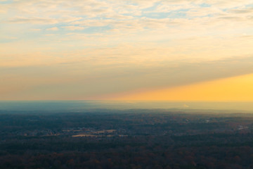 Fototapeta na wymiar Aerial view of forest and settlements from the top of the Stone Mountain at sunset, Georgia, USA
