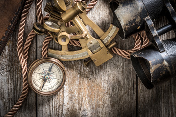 compass,sextant and spyglass on the timber