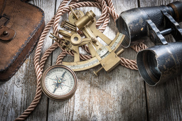compass,sextant and spyglass on the timber