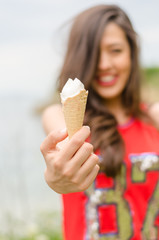 Portrait of beautiful happy smiling emotional young woman eating delicious ice cream