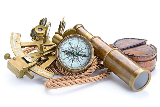 compass,sextant and spyglass on the white
