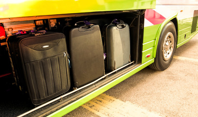 Checking luggage or suitcase compartment on bus. Many heavy luggage load into a bus locker.