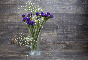 Purple and white flower bouquet in vase
