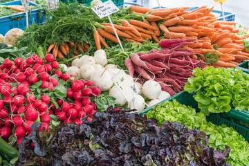 Radish, carrots and other vegetables for sale at a market