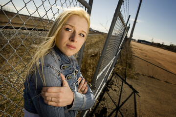 Woman Against Fence