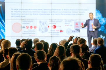 Audience listens to the lecturer at the conference hall