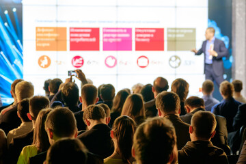 Audience listens to the lecturer at the conference hall