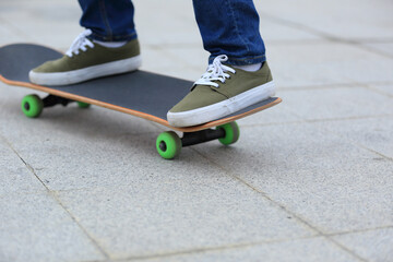 Fototapeta na wymiar young skateboarder legs practicing at skatepark