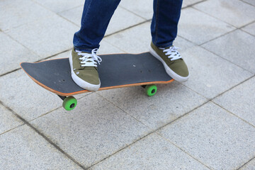 Fototapeta na wymiar young skateboarder legs practicing at skatepark .