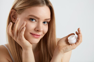 Naklejka premium Woman Face Skin Care. Girl Applying Cream Under Eyes