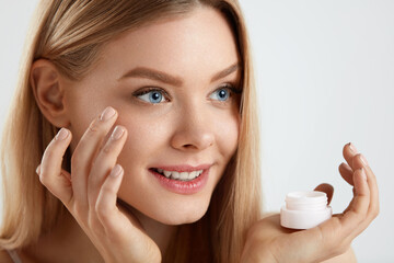 Woman Face Skin Cosmetics. Girl Applying Cream Under Eyes