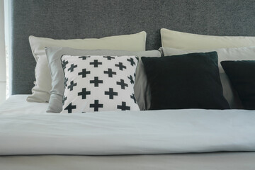 Modern bedroom interior with pillows in black and white color scheme