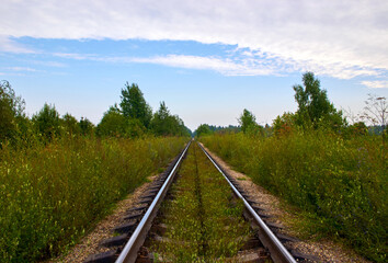 Fototapeta na wymiar Old rails in landscape. Railway to horizon.