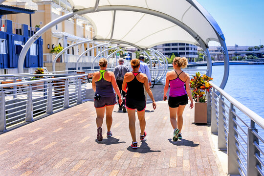 Group of women in jogging clothes on the Riverwalk in downtown Tampa FL