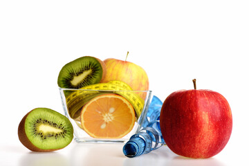 Fresh fruit including yellow apple, kiwi fruit and orange halves
