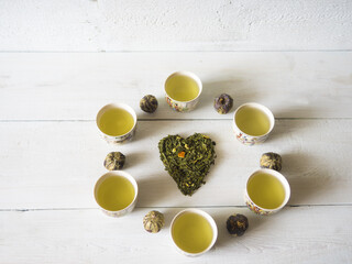 Naklejka na ściany i meble Green tea teapot white board background tea hert