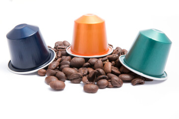 coffee capsules with coffee beans on white background