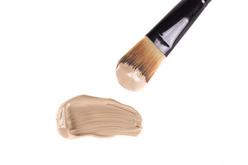 Cosmetic liquid foundation and professional brush isolated on white