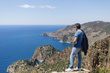 Tourist looking at sea bays in Antiochia ad Cragum