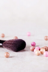 Blush in the balls and make-up brushes close-up