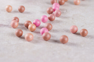 Cosmetics blush in the balls scattered close-up