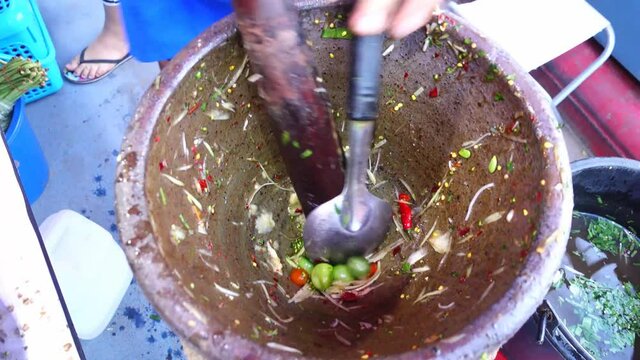 Thai people cooking green papaya salad or som tum at street food, Thailand 

