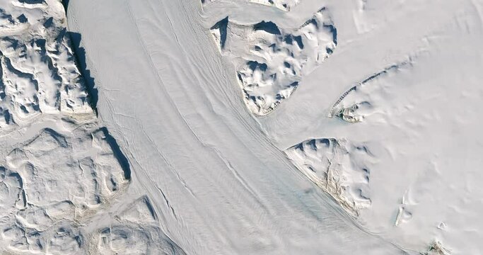 High-altitude overflight aerial of Petermann Glacier on Greenland's northwest coast. Clip loops and is reversible. Elements of this image furnished by USGS/NASA Landsat