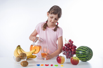 Little girl pouring glass of juce - healthy food concept - isolated