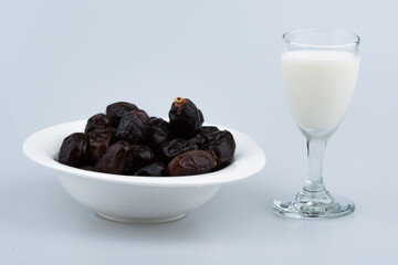 Isolated dates with milk in a plate 