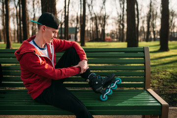 Roller skater posing on the bench in skates