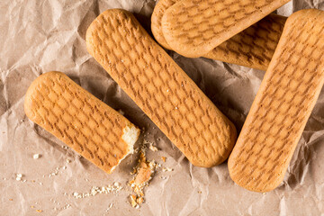 Flat lay above brown biscuit cookies on the wrinkled paper