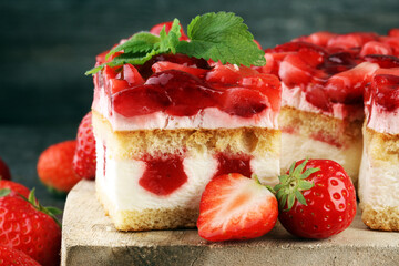 strawberry cake and many fresh strawberries on grey background
