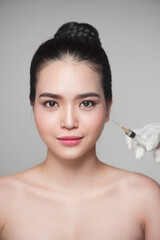 Beautiful asian woman gets beauty facial injections. Face aging injection.