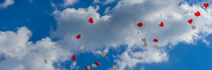 Fototapeta na wymiar Heart balloons flying into the sky at a wedding