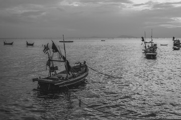 Fisherman boat on the sea black and white.