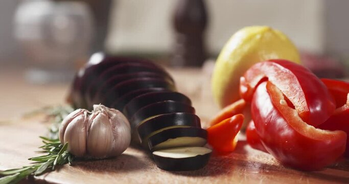 Slide shot of fresh vegetables, eggplant, bell pepper, lemon, garlic and rosemary, 4k prores footage