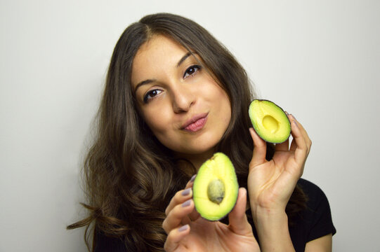 Portrait of attractive girl with avocado healthy fruit