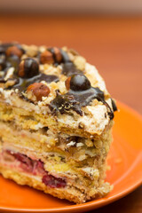 Piece of cake with hazelnuts and chocolate - in a saucer