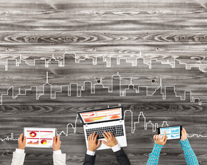 Top view of businesspeople sitting at table and using gadgets