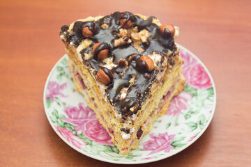 Piece of cake with hazelnuts and chocolate - in a saucer