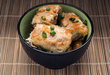 A cup with pieces of fried fish