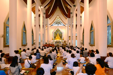 People praying in Buddhist church.